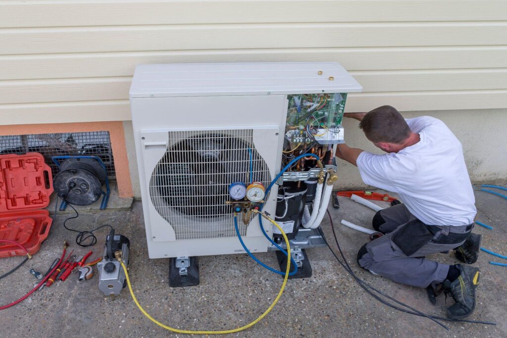 plumber at work installing a circulation heat pump