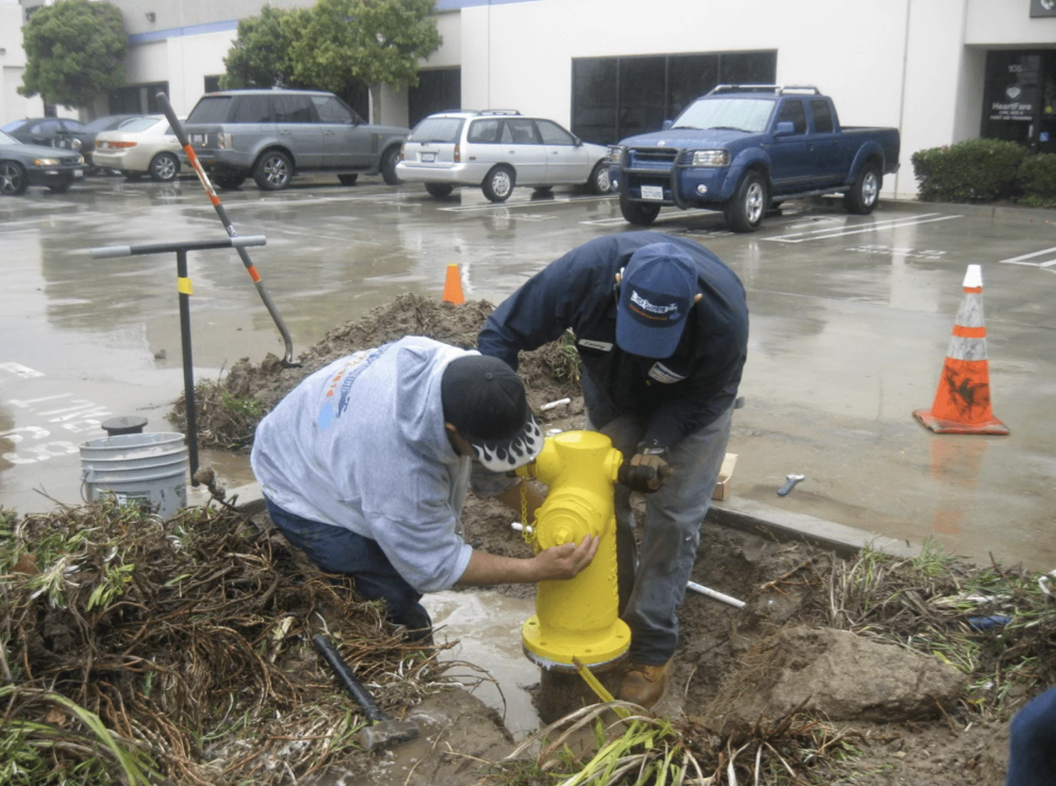 plumbers fixing leaking fire hydrant