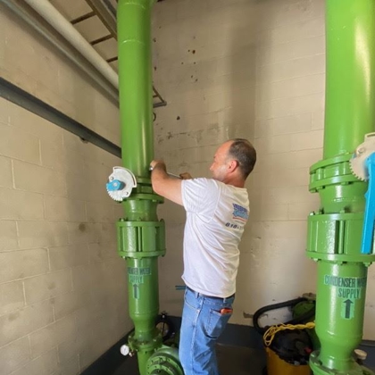 plumber tightening a bolt for boiler