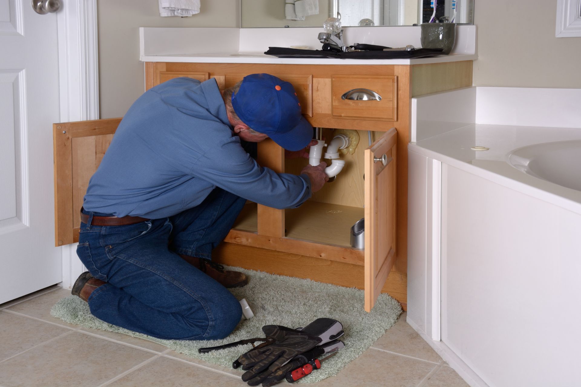 Plumber repairs kitchen sink