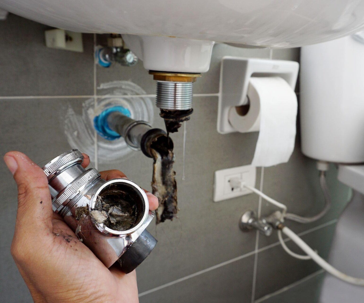Hand Of Plumber Holding Joints And Connections Of Basin Or Sink In A Bathroom