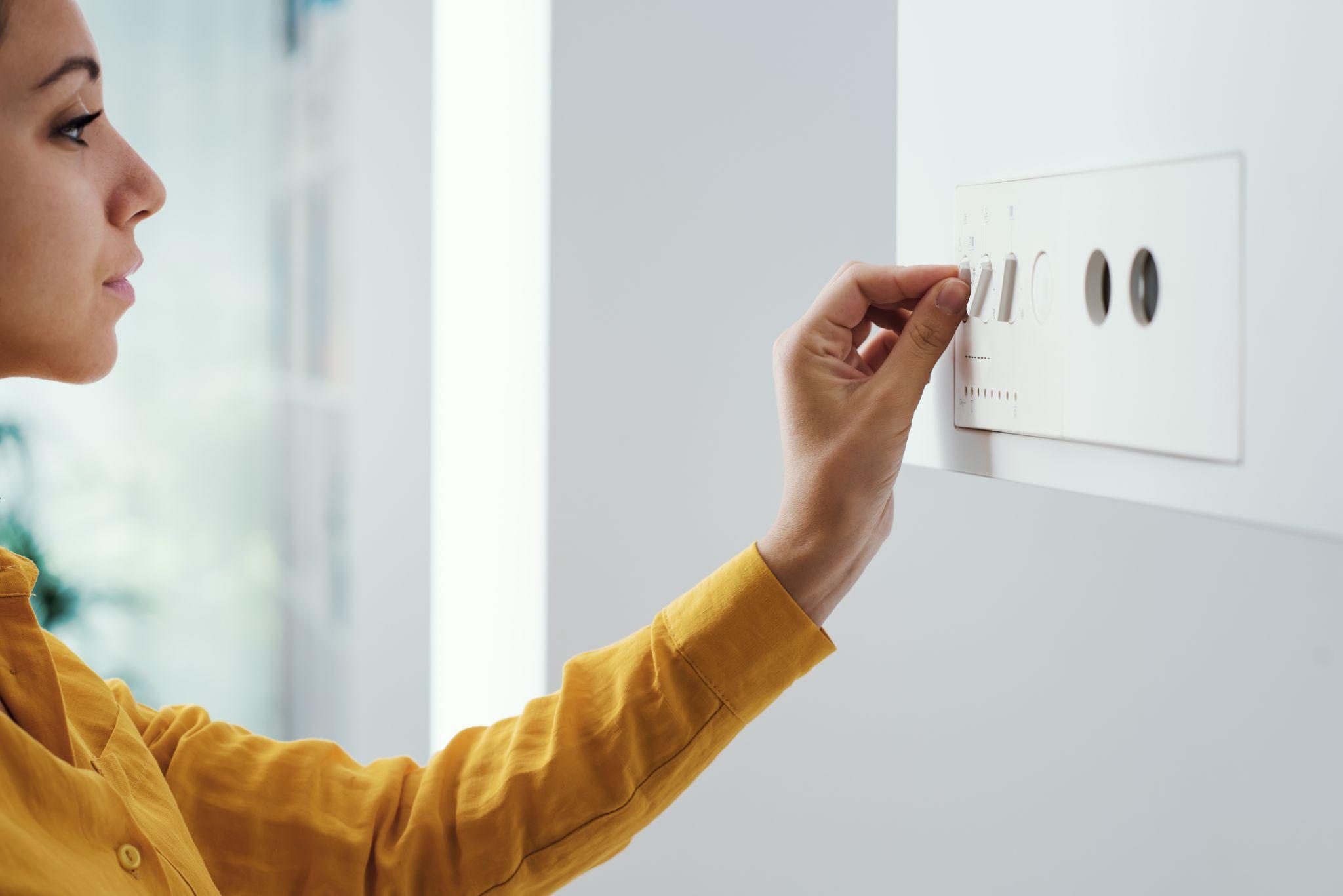 Woman checking settings on the boiler