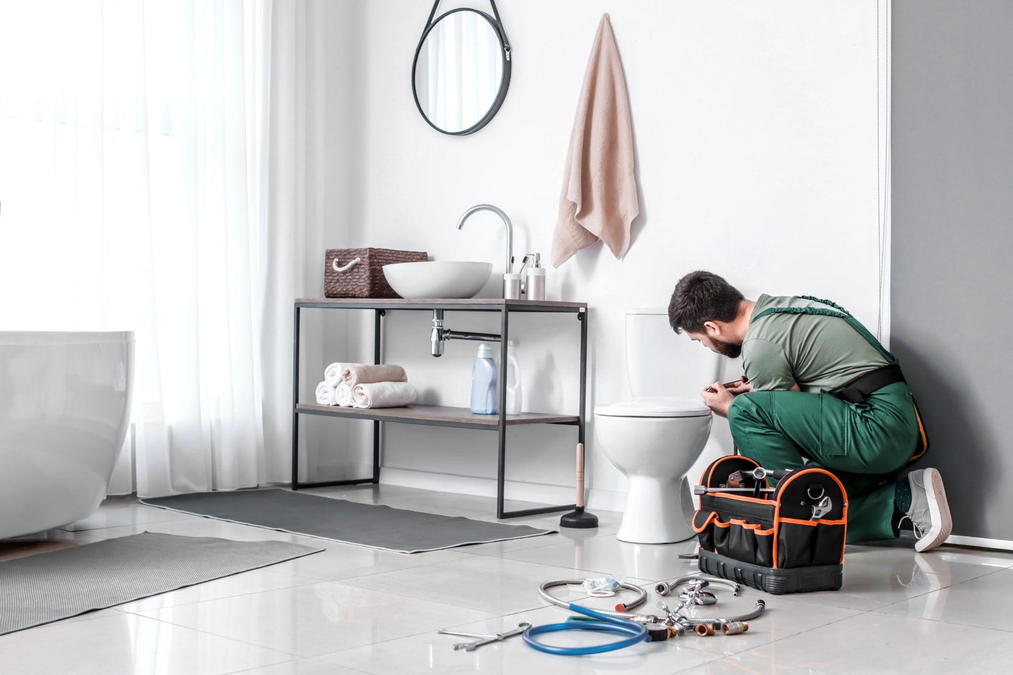 Plumber fixing a weak flushing toilet 