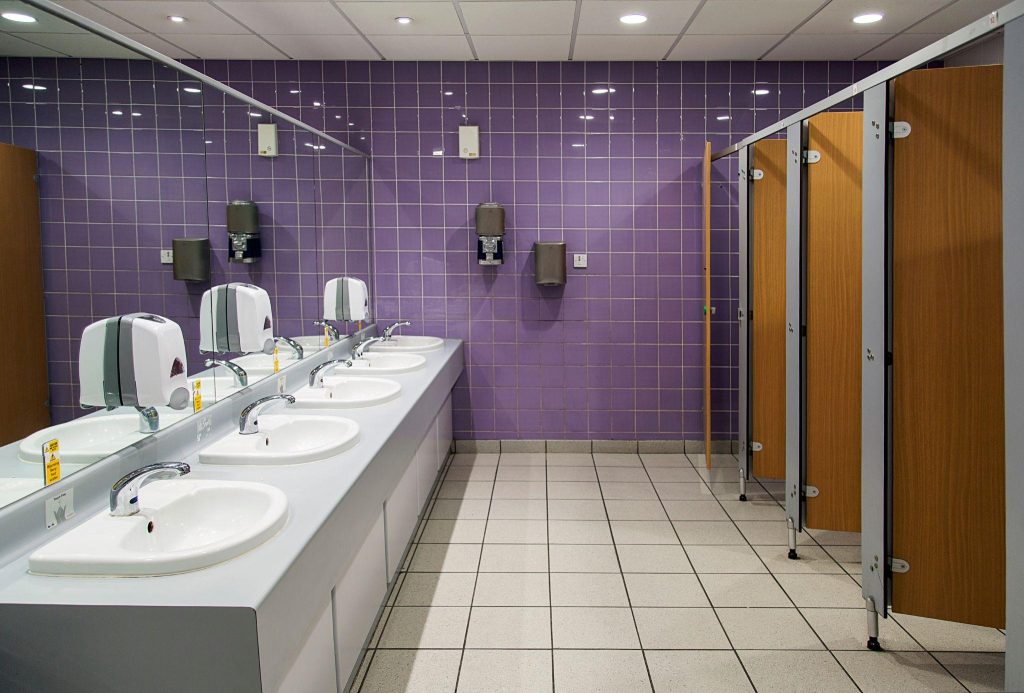 Public Bathroom with sinks, mirrors and cubicles