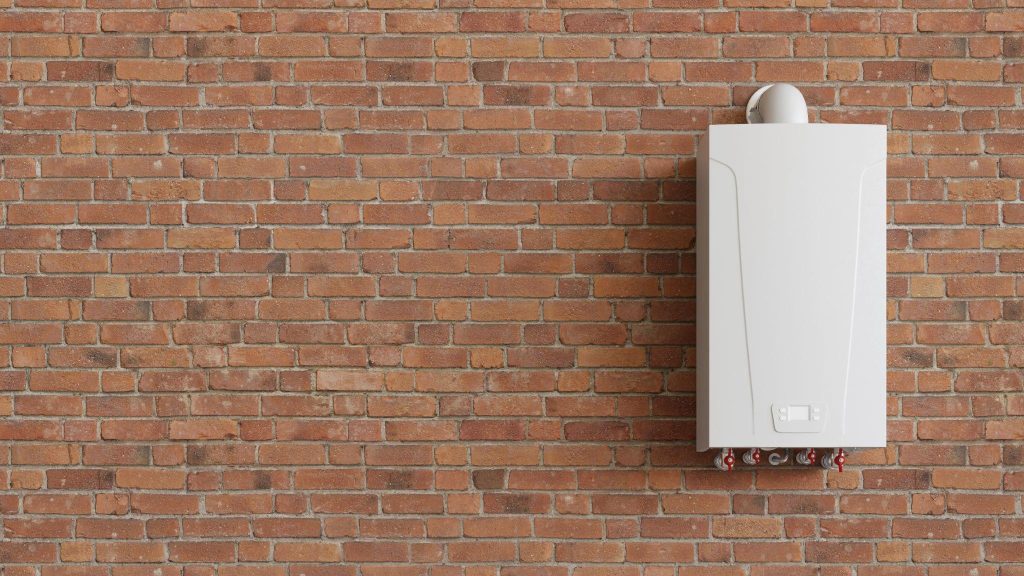 A tankless water heater attached to a brick wall