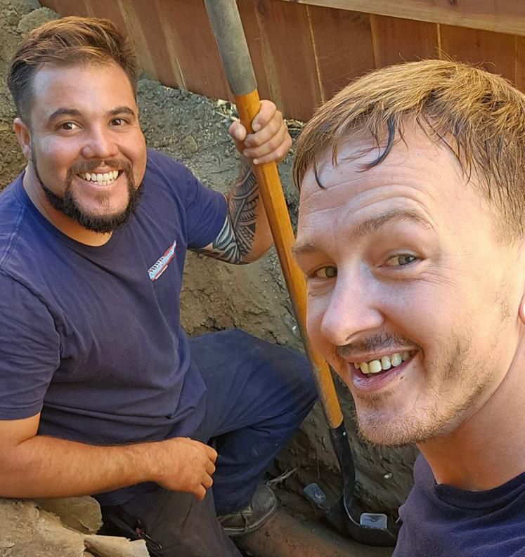 Two Plumbers performing a sewer line repair