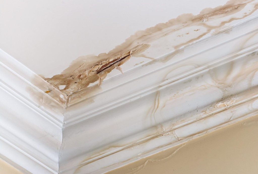 A ceiling with visible water damage